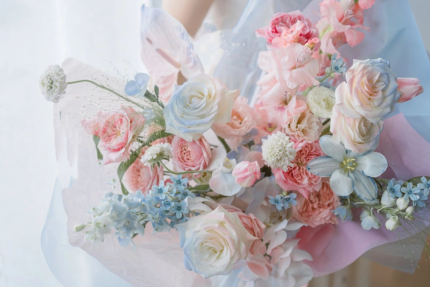 A bouquet of soft blue and pink flowers